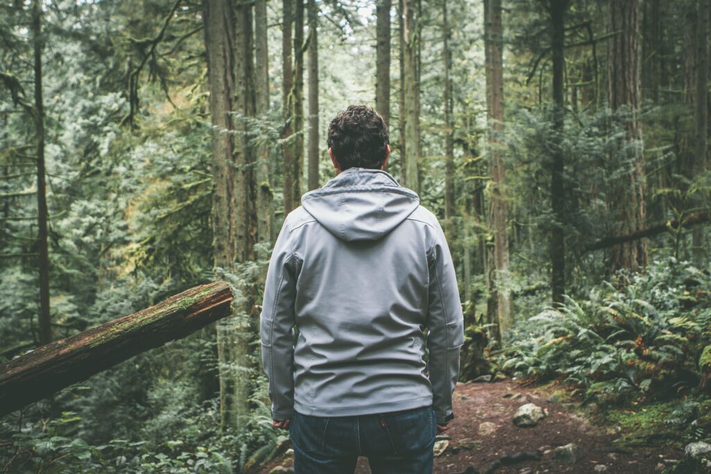 man standing in woods