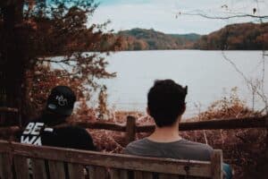 two people sitting on the bench