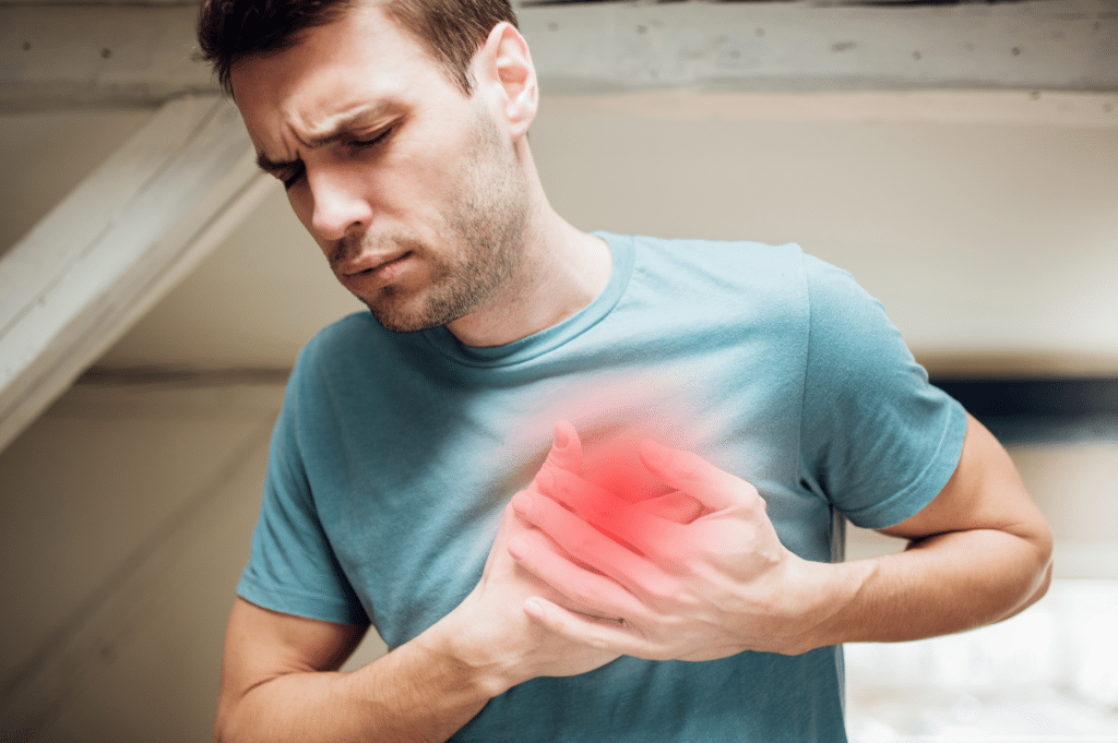 Man holding his heart due to heart infection due to heroin use.