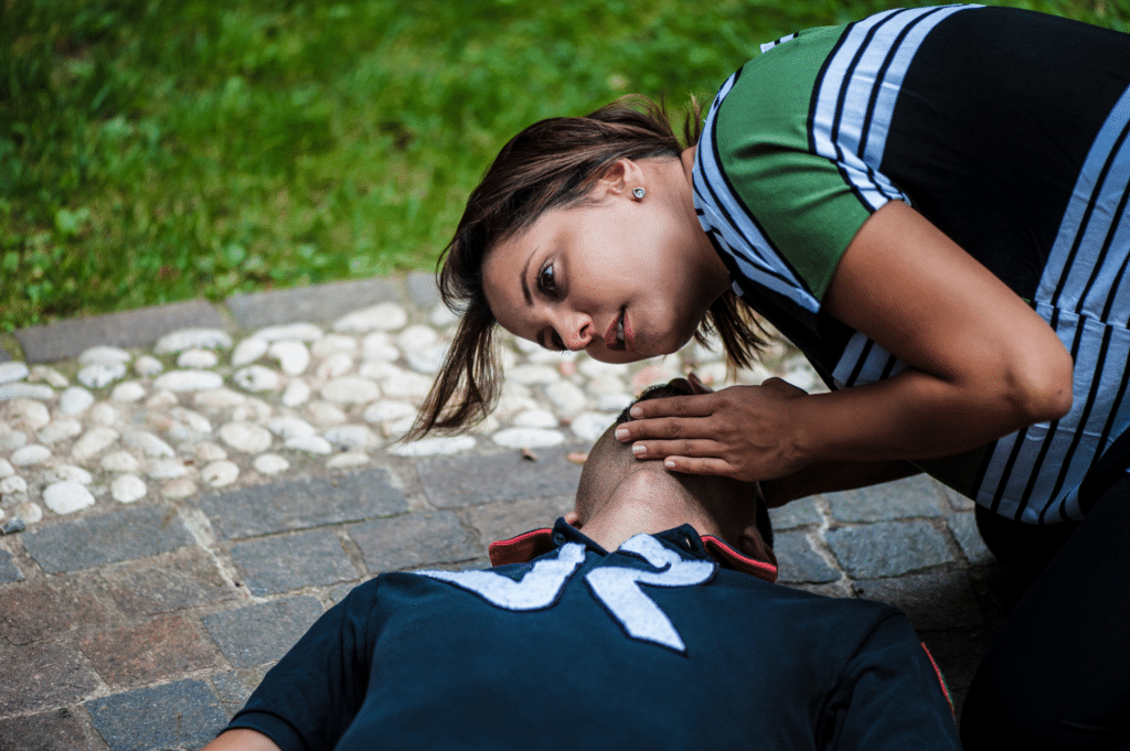 Woman helping a man that is overdosing on Carfentanil